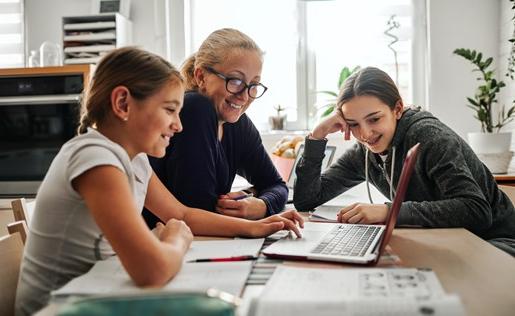 Mom and two daughters using a laptop